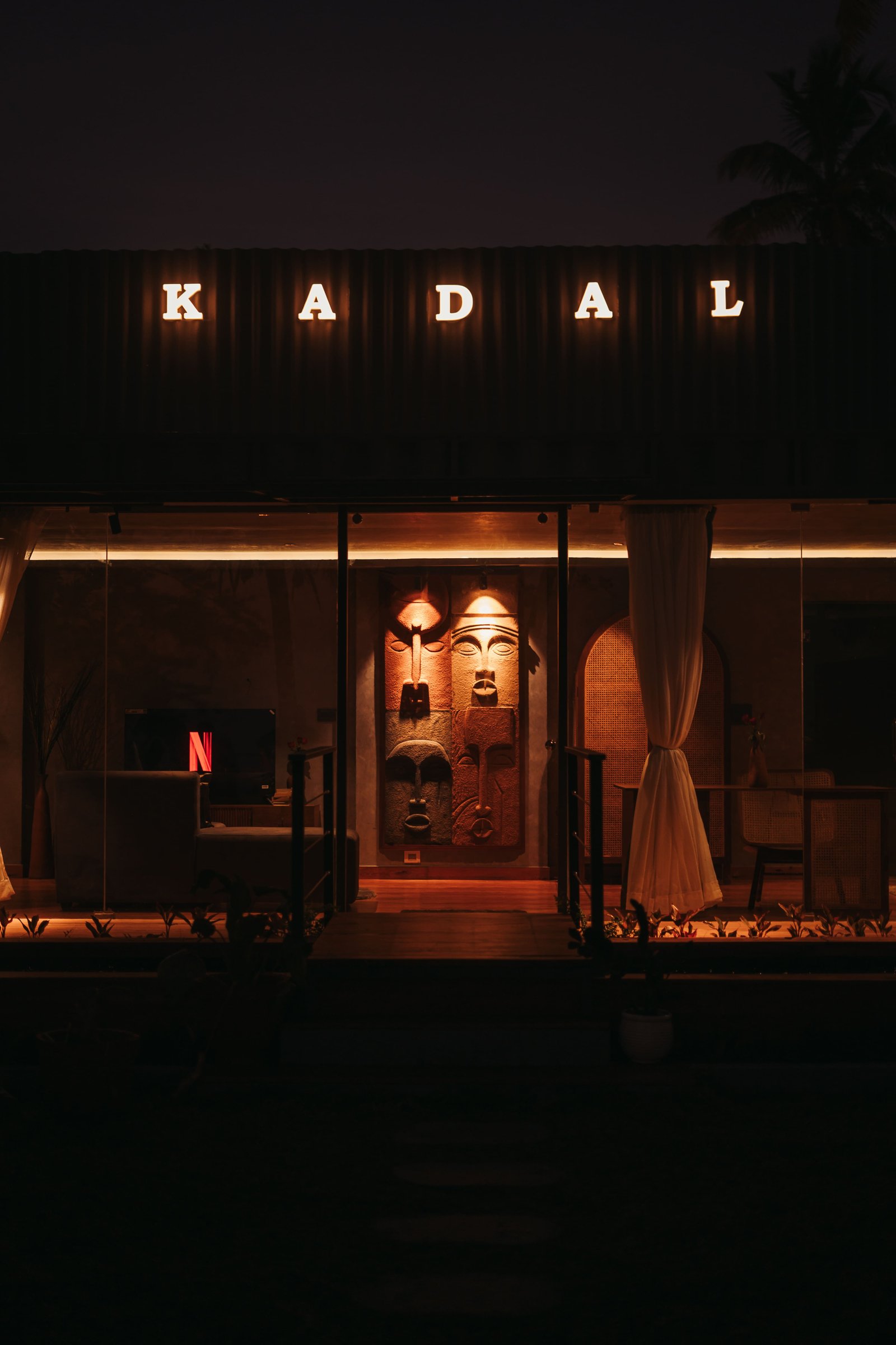 Kadal Villa - Best luxury container villa exterior at night on Varkala south cliff with warm lighting and ocean view